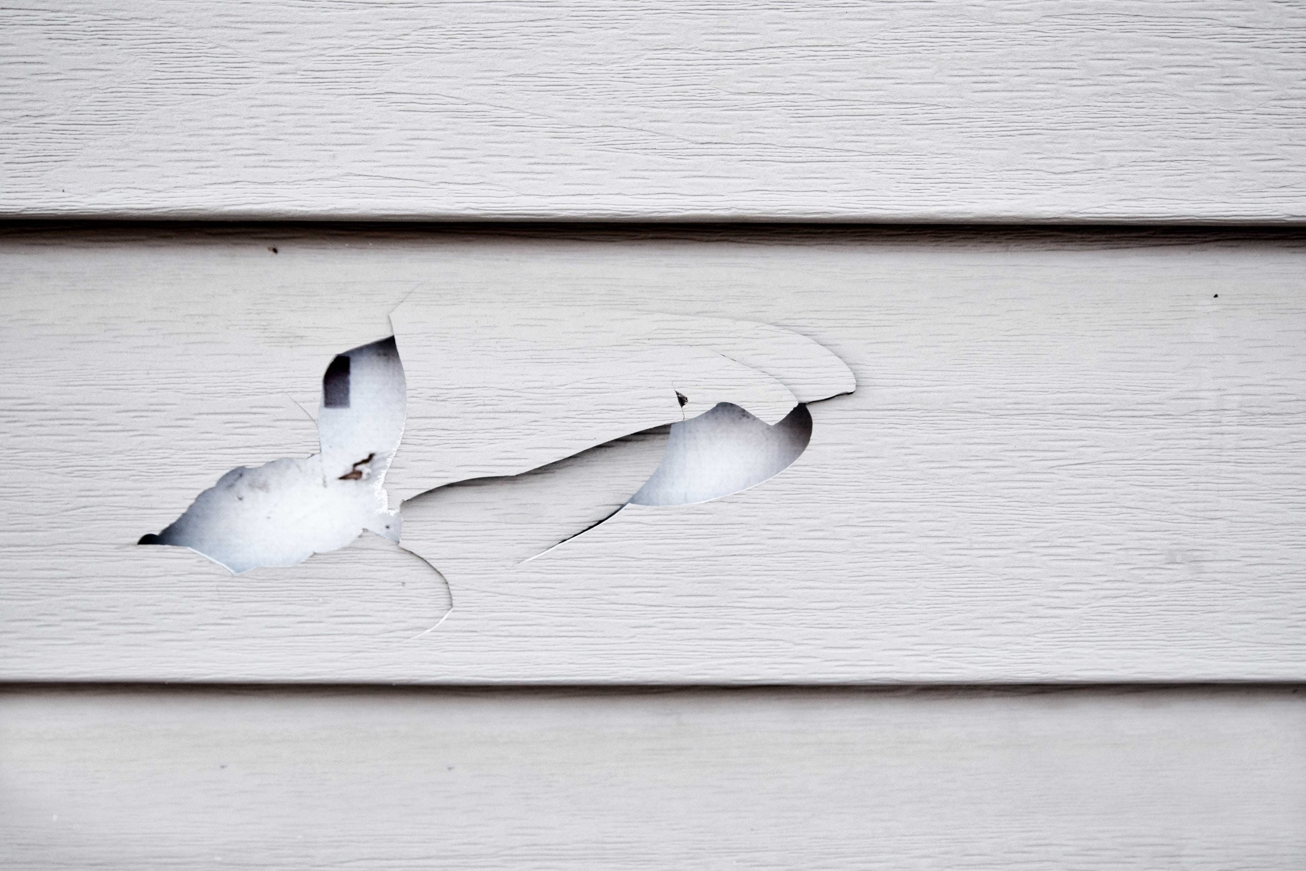 A hole in vinyl siding requires professional siding repair.