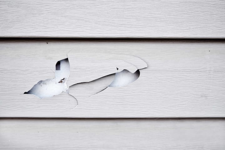 A hole in vinyl siding requires professional siding repair.